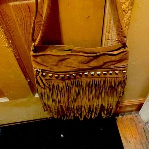 Soft leather with fringes and brand new , medium size.